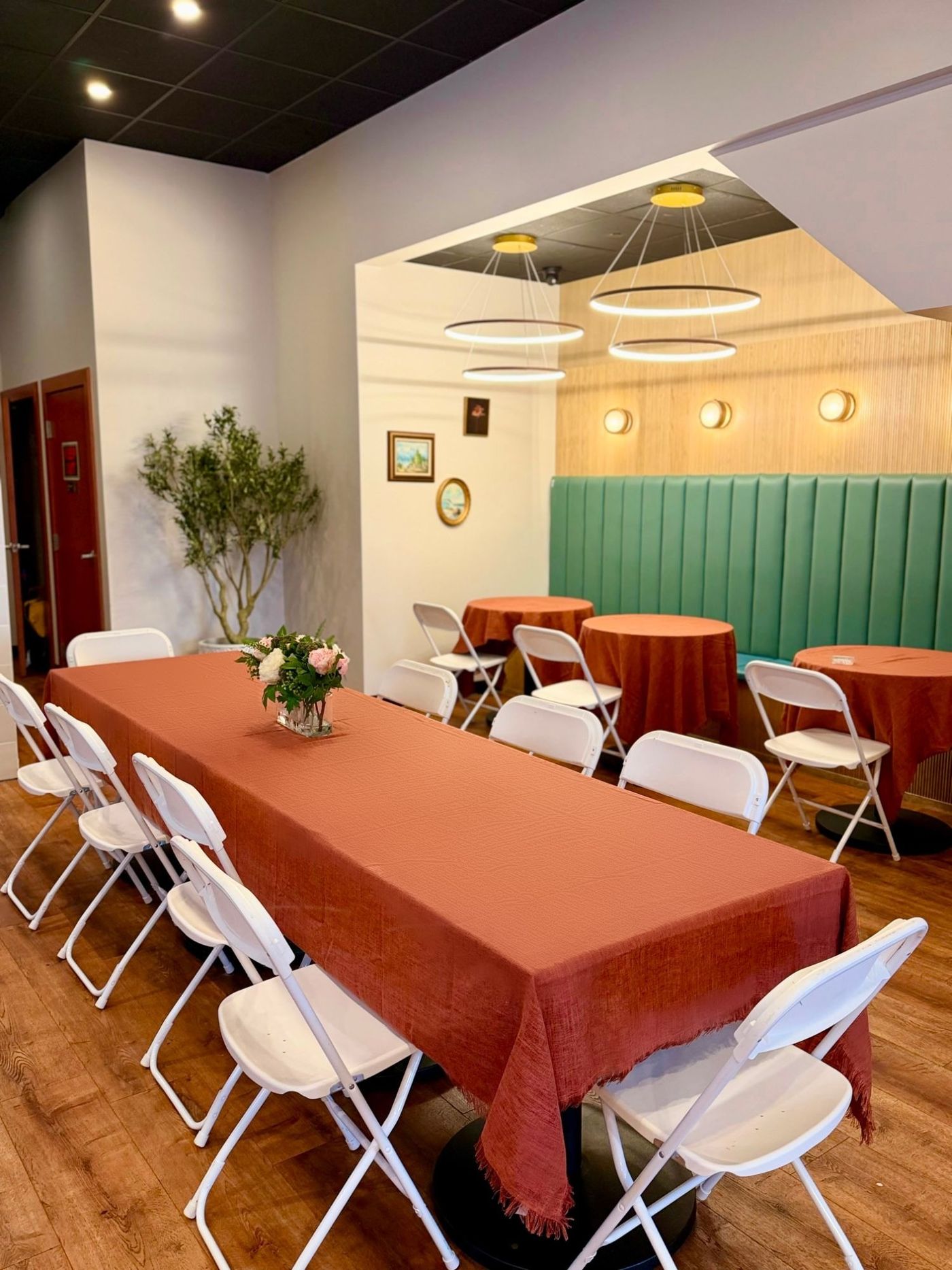 The Nook: a long table and banquette seating under ring lights