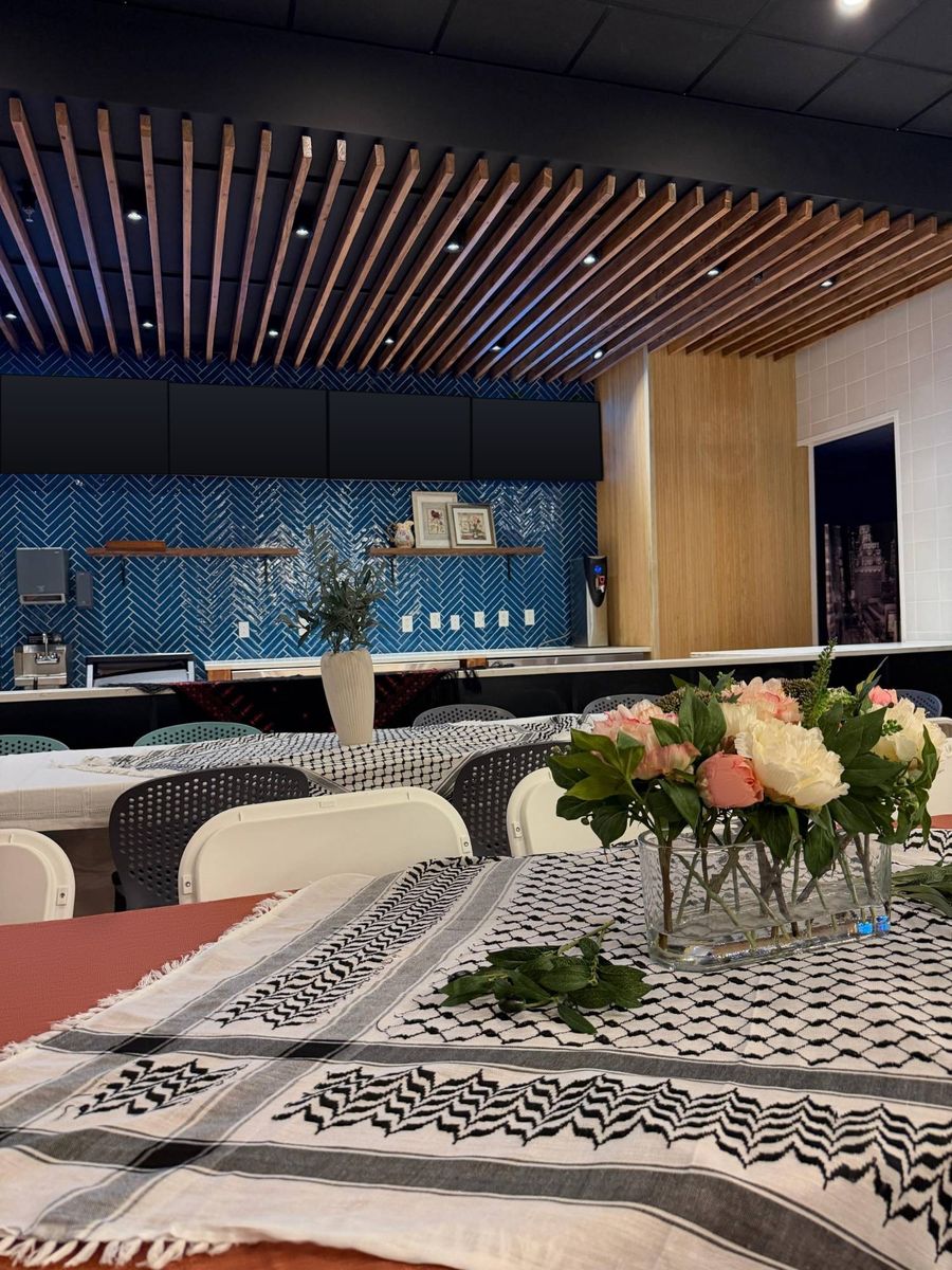A table dressed with a runner and flowers